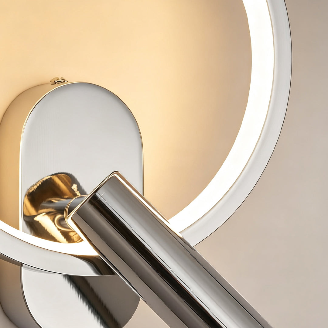 Detailed view of reading light for bed wall mounted featuring warm LED halo and chrome spotlight.