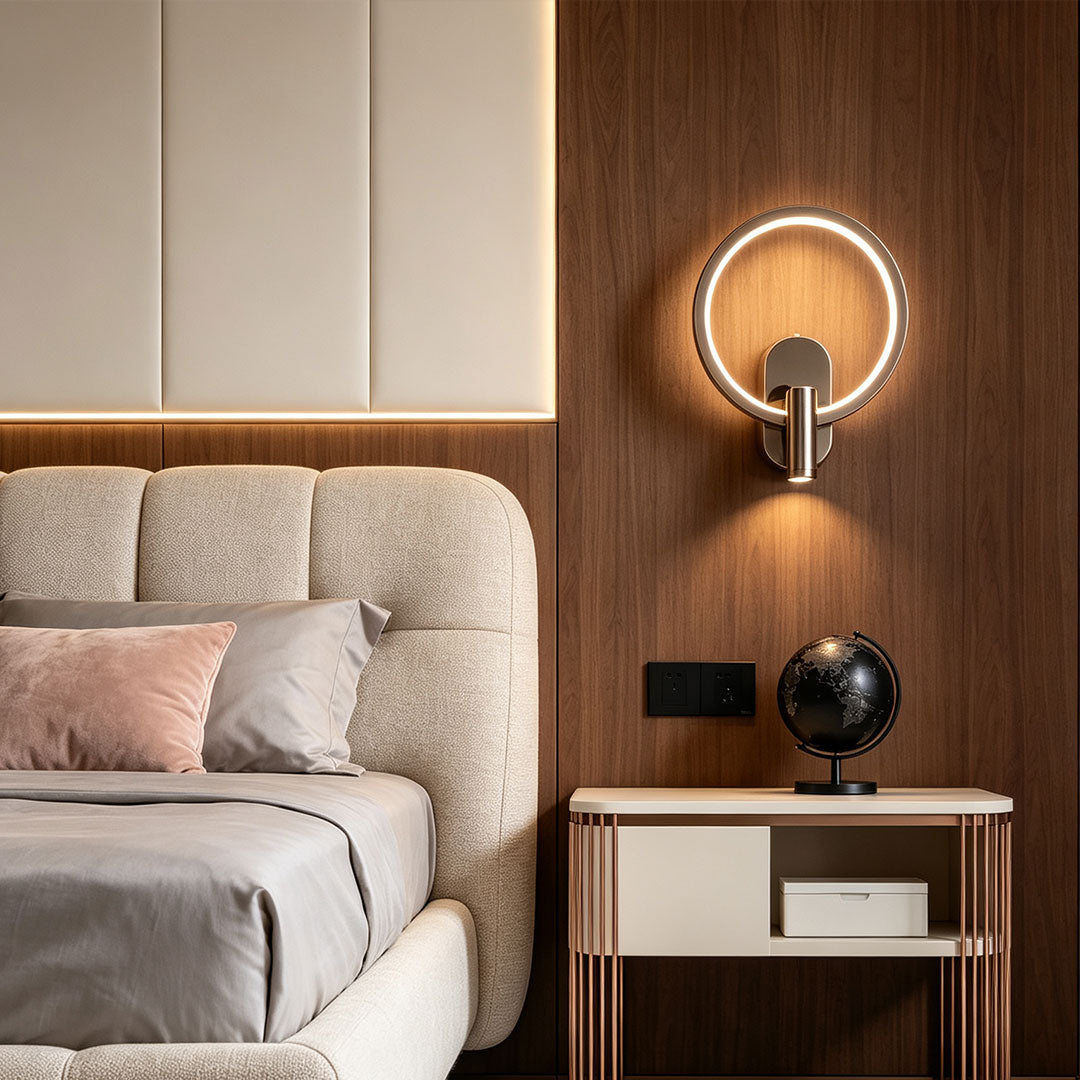 Modern reading light for bed wall mounted beside upholstered headboard with glowing circular LED halo.