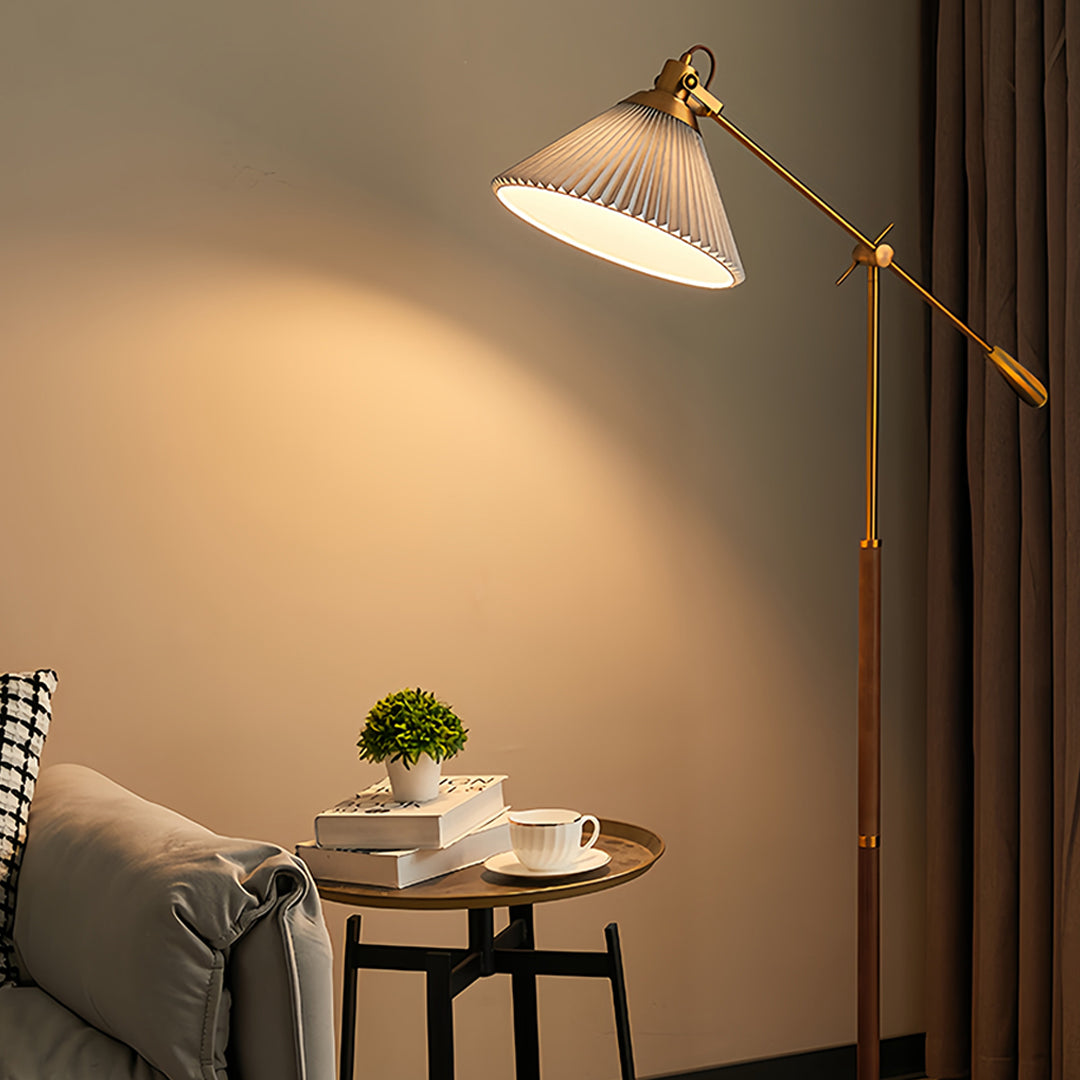 Contemporary reading nook showcasing small black pendant light with adjustable brass arm and white shade