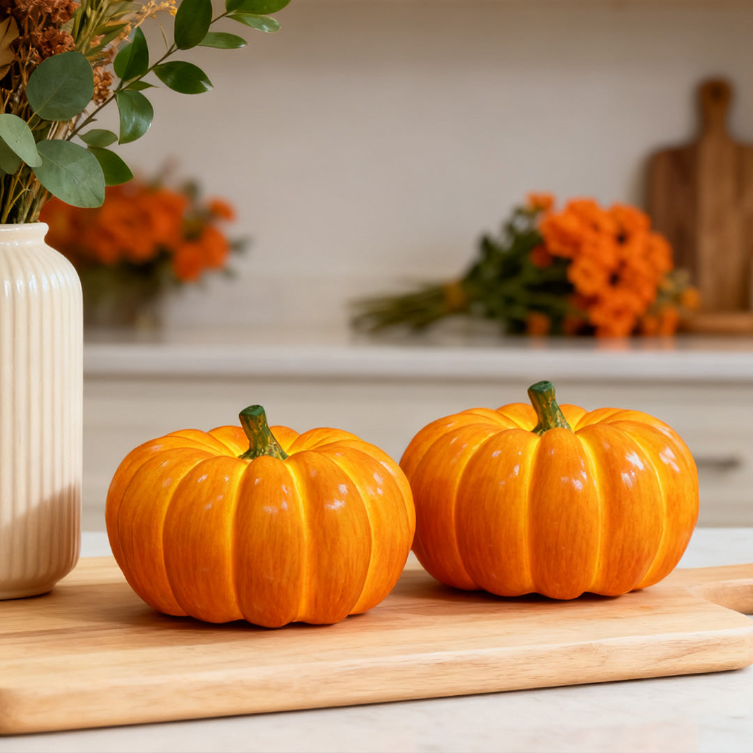 Realistic halloween pumpkin light models used as autumn decor on a kitchen counter.