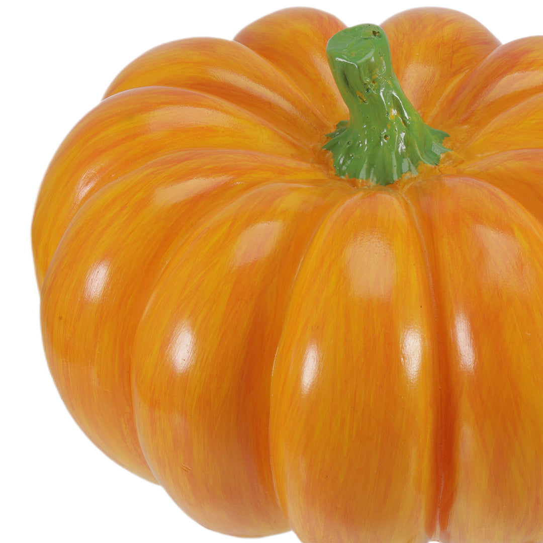 Close-up detail of a realistic halloween pumpkin light showcasing its texture and green stem.