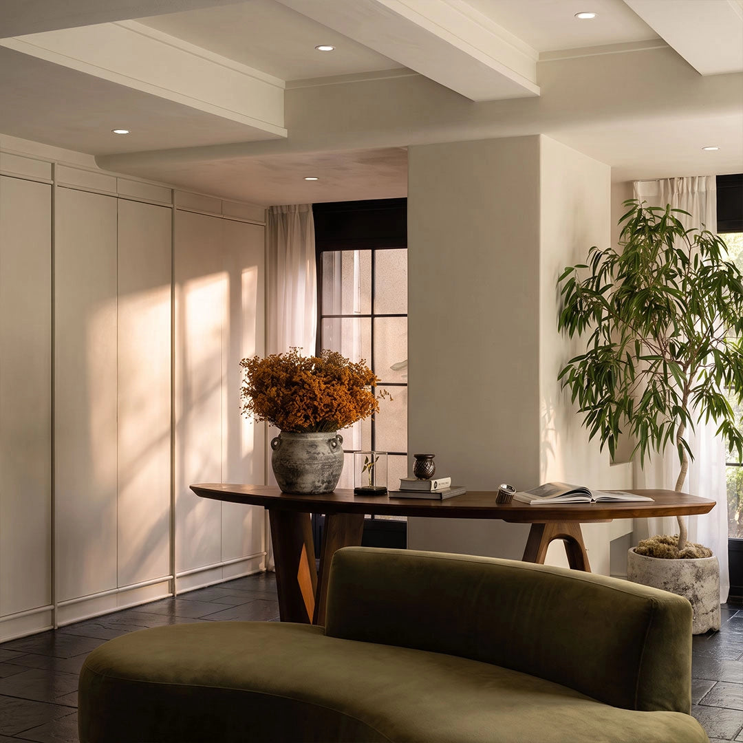 Recessed adjustable downlight fixtures mounted in a bright contemporary living space, providing clean directional ceiling illumination.