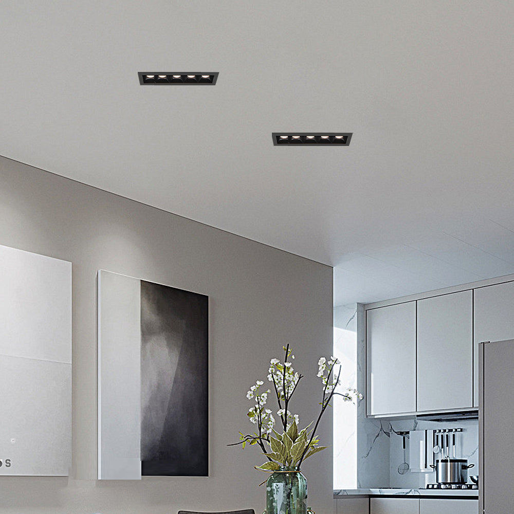 Close-up view of recessed ceiling spot light with multiple LED lenses.