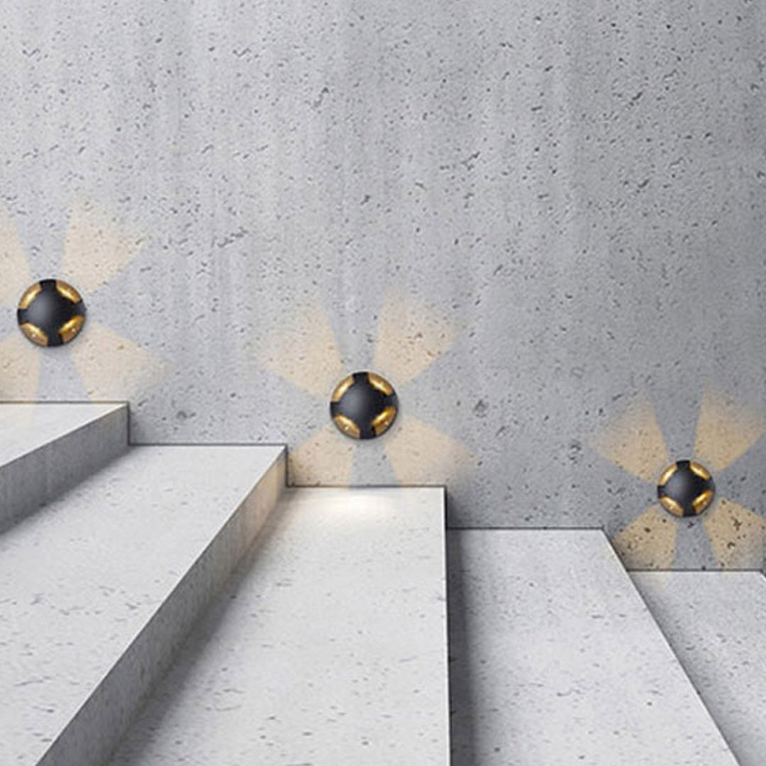 Close-up view of black cylindrical ground fixture showing precision-engineered directional design