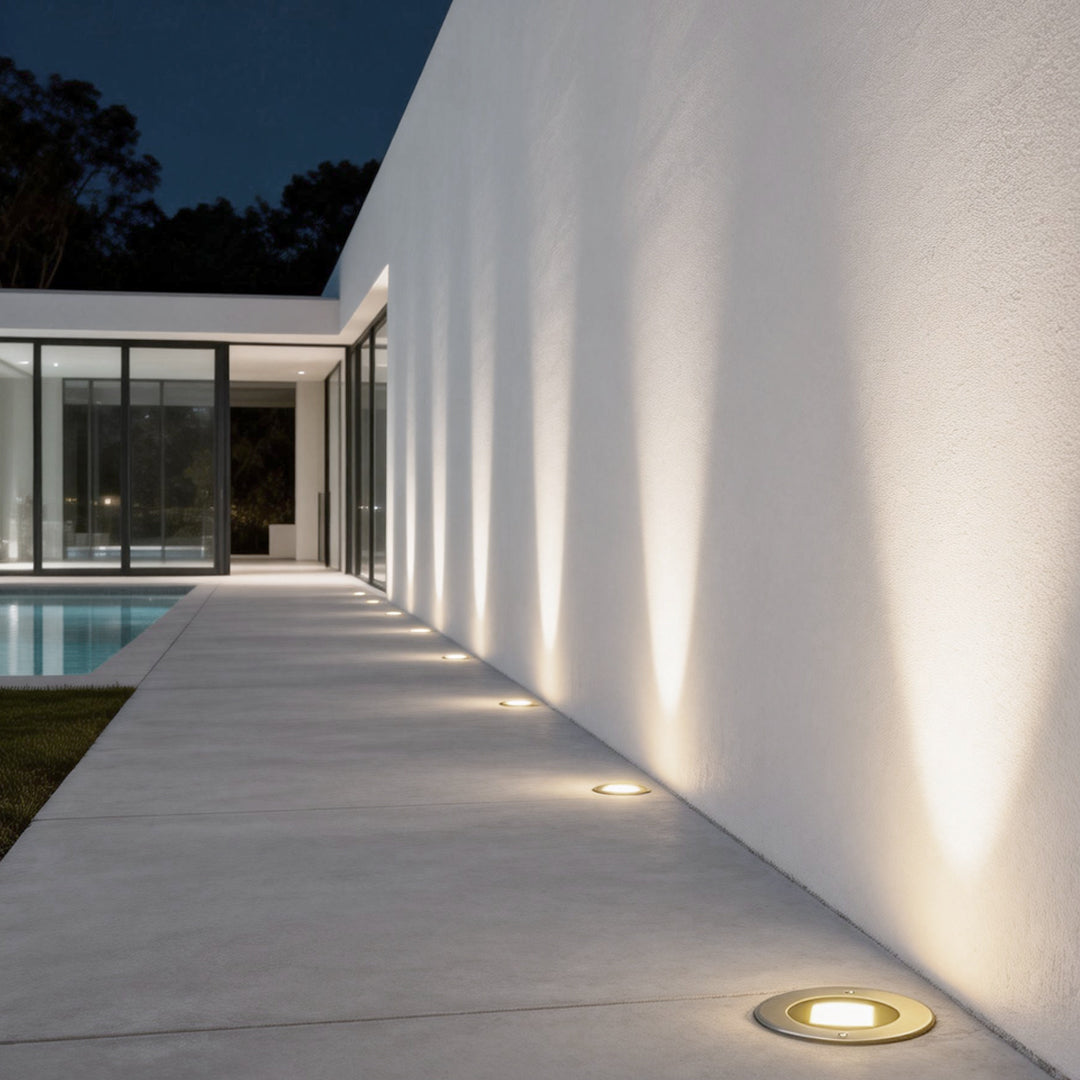 Recessed deck step lights providing subtle illumination along a modern walkway.