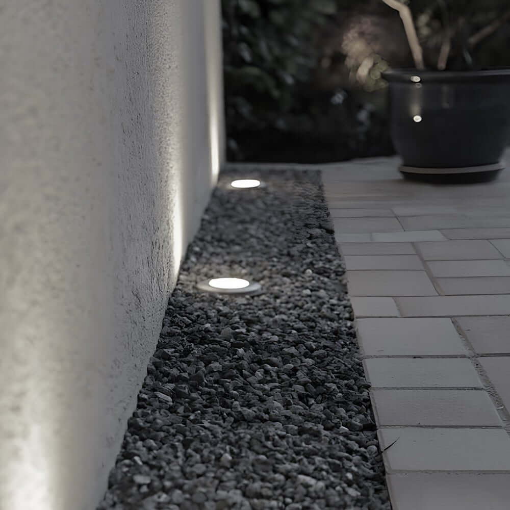 Recessed floor lighting illuminating a concrete walkway at dusk for safe and elegant outdoor navigation.