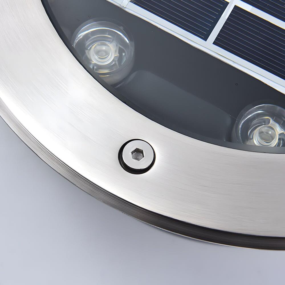 Recessed floor lighting near decorative plants, blending functionality and aesthetics in garden design.