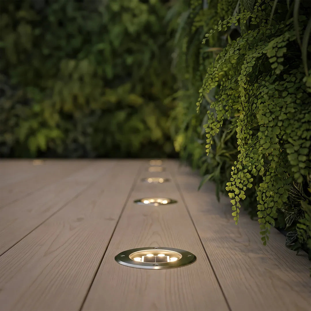 Recessed floor lighting embedded in a wood deck walkway with small in-ground lights guiding the outdoor path.
