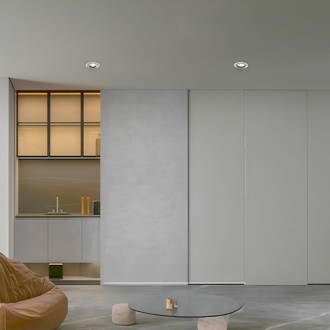 Recessed led ceiling downlights providing clean, ambient light in a minimalist grey room.