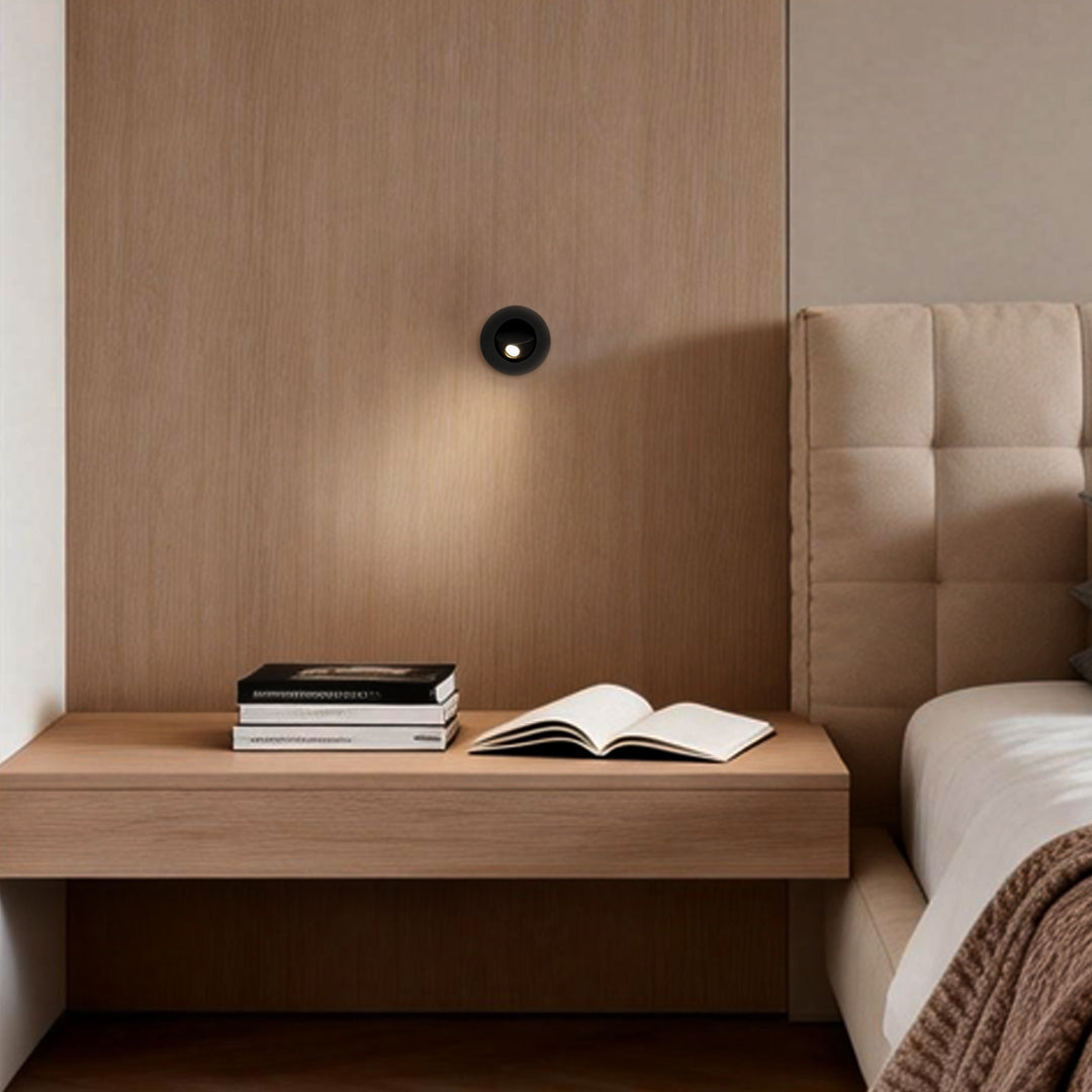 Wood panel headboard integrated with recessed led reading lamp for soft task lighting.