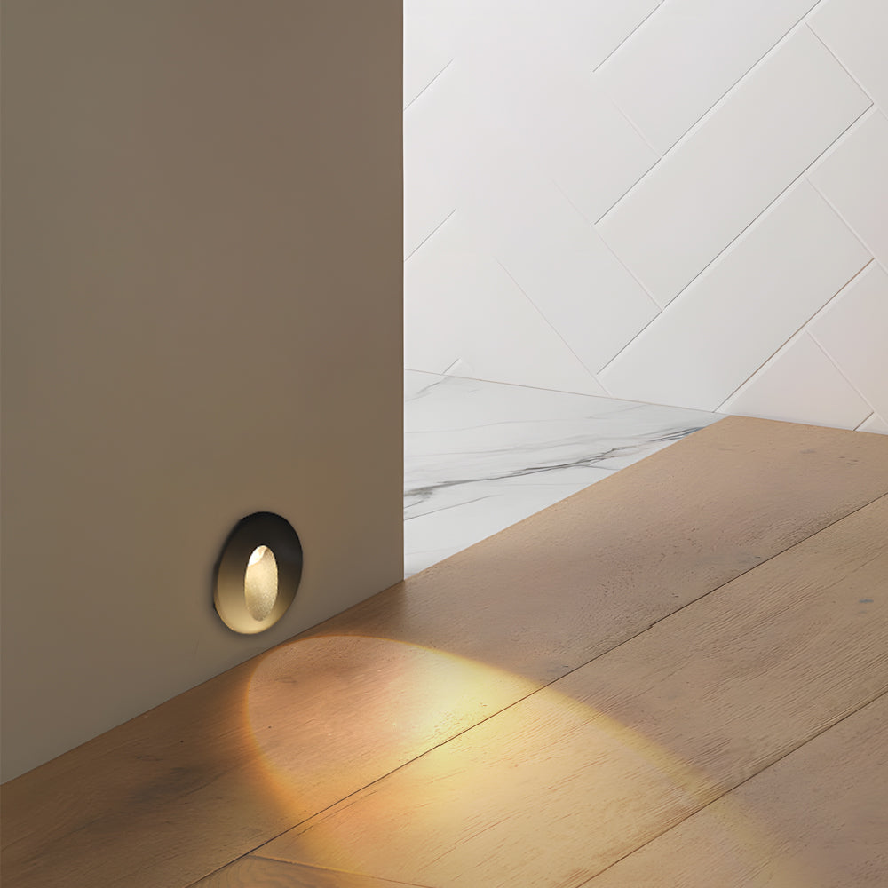 Recessed LED step light with subtle warm glow illuminating modern stone steps for elegant pathway lighting solution