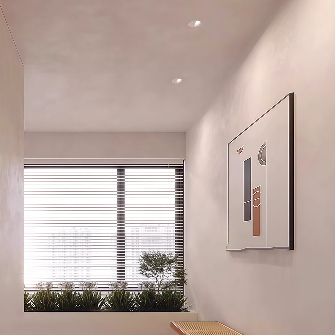 Recessed spotlight illuminating bright bedroom with window seat and minimalist decor