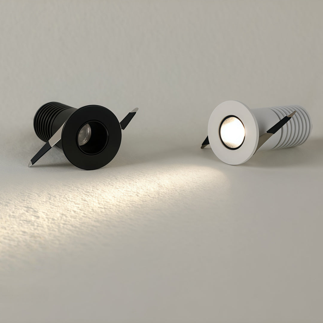 Black and white recessed ceiling spotlight fixtures displayed with chrome and powder-coated finishes
