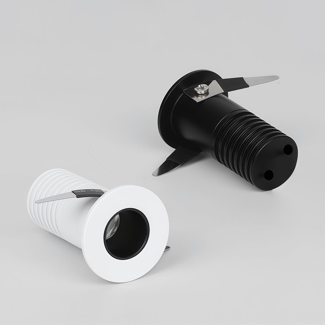 Comparison view of black and white recessed ceiling spotlights showing different finish options