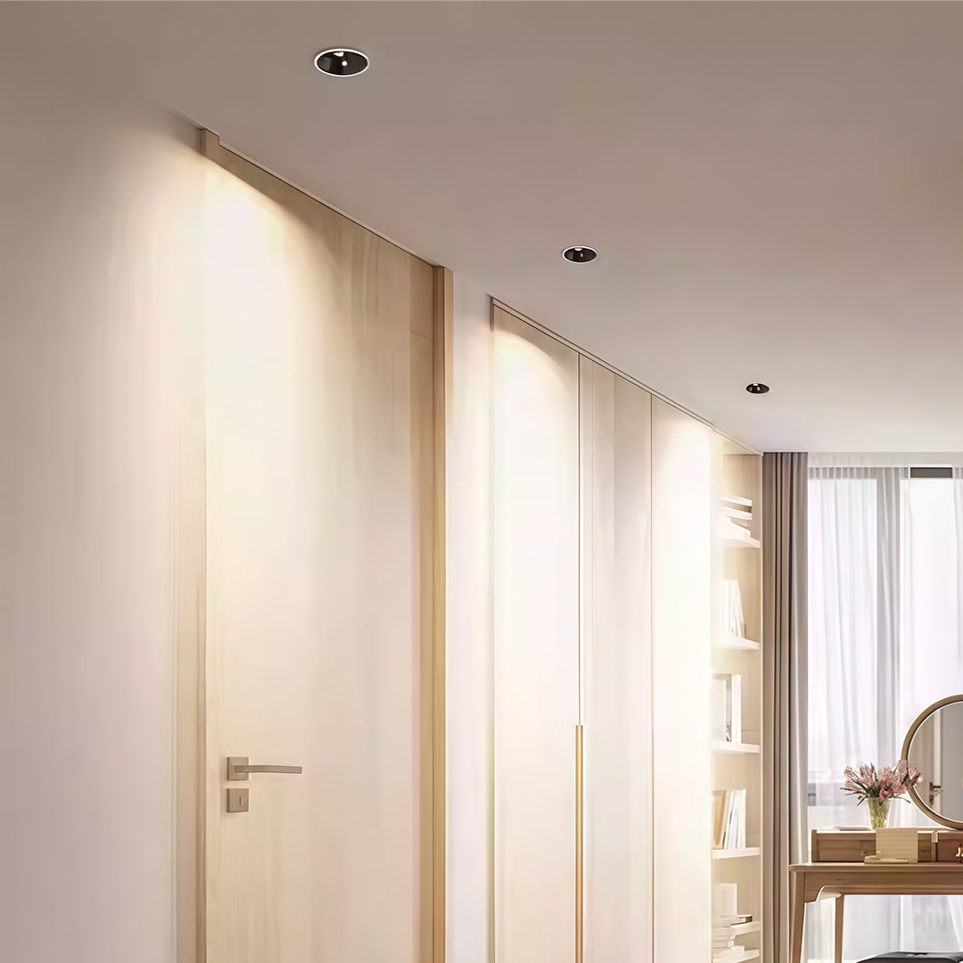 Recessed spotlights enhancing modern hallway with warm walls and floor-to-ceiling doors
