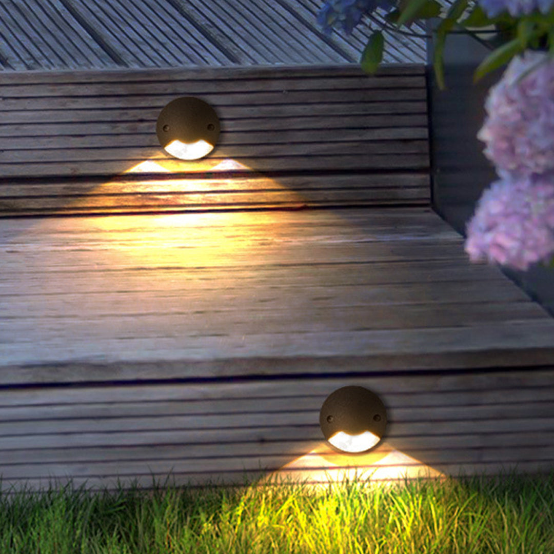 Modern recessed outdoor lighting creating warm illumination on wooden deck steps at night