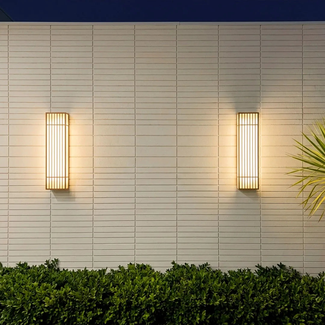 Rectangle LED outdoor wall lights arranged on a clean exterior wall above low landscaping.