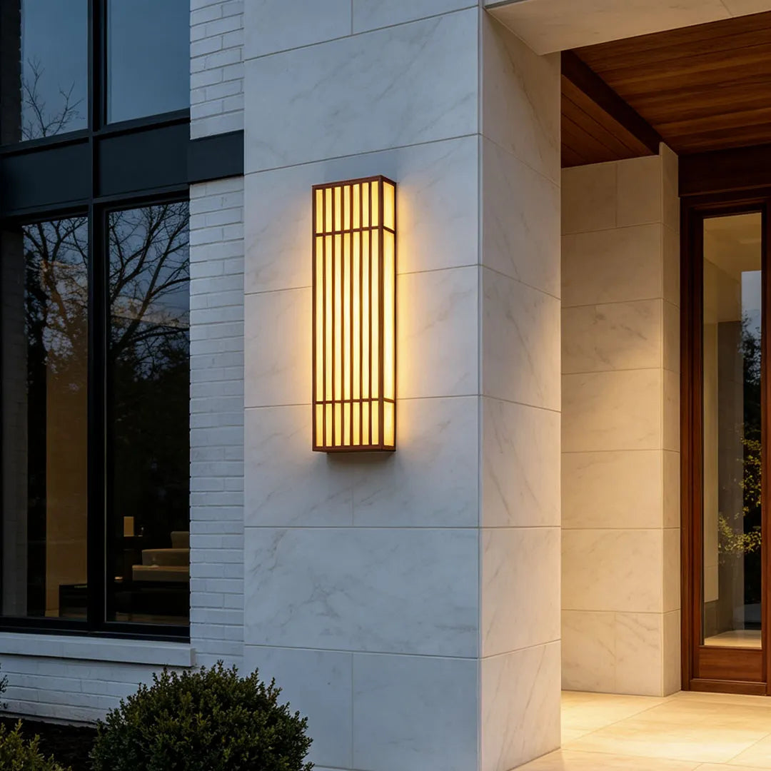 Rectangle LED outdoor wall light mounted beside a contemporary entry with stone cladding and warm illumination.