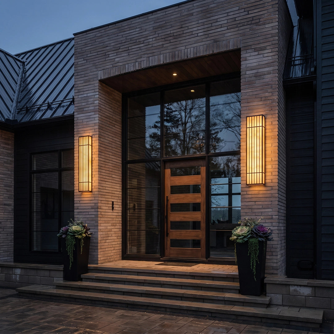 Rectangle LED outdoor wall lights installed beside a modern front entry on a brick exterior.
