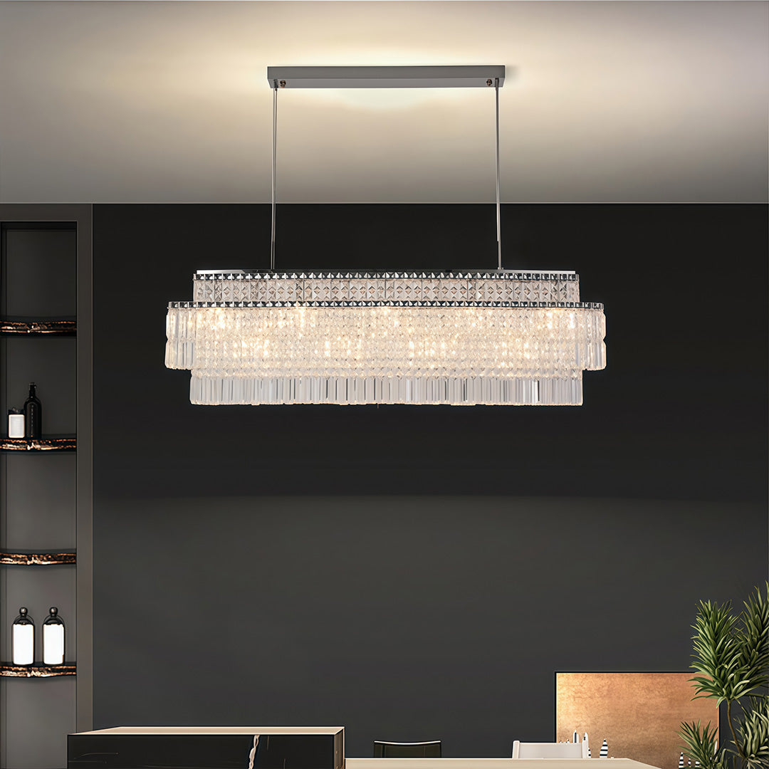 Rectangular chandelier with round crystals brightening modern dining space with black wall and pendant lighting.