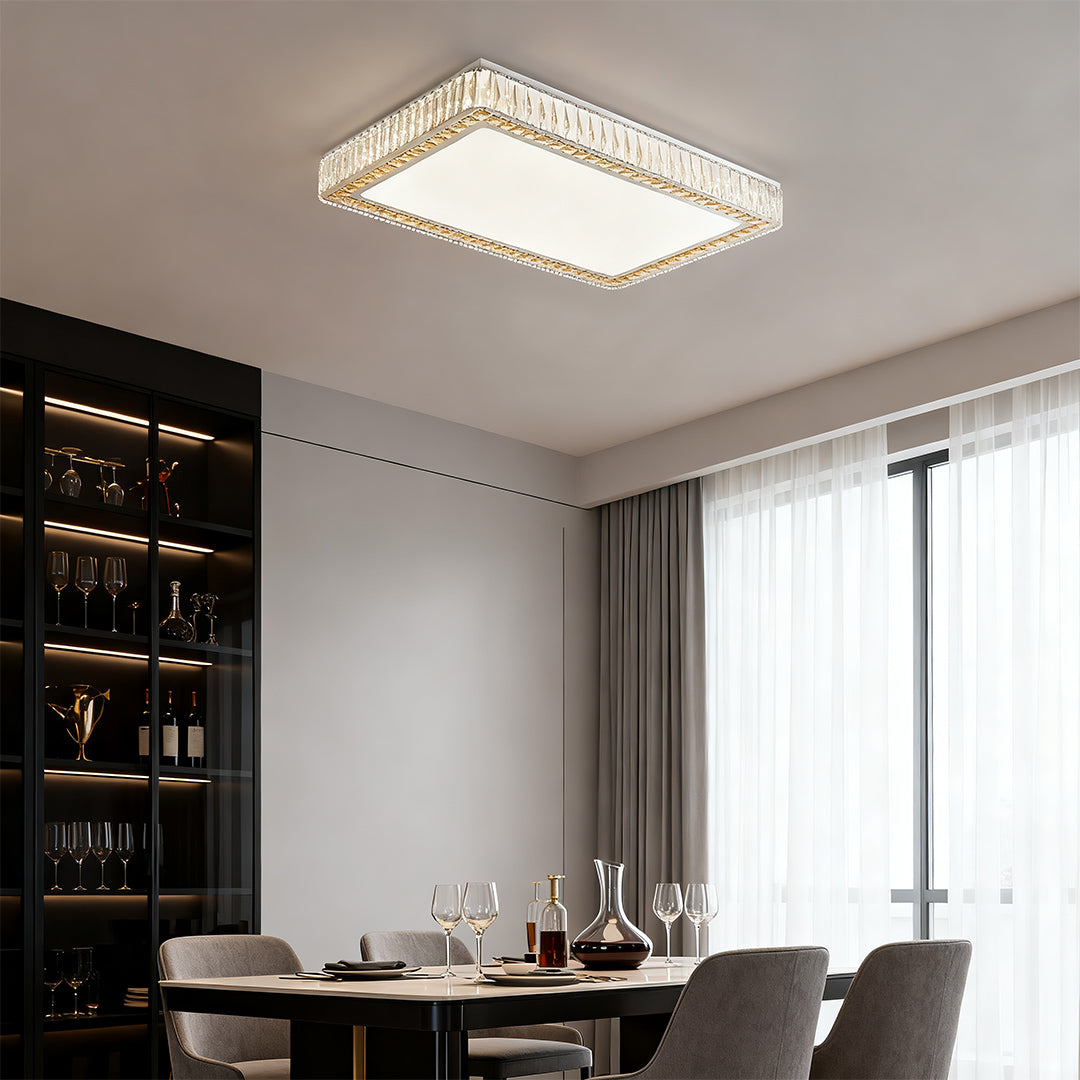 Rectangular crystal ceiling light enhancing a minimalist dining space with warm ambiance.