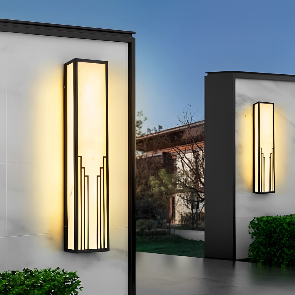 Rectangular exterior wall sconce with a close-up of its glowing light and geometric design.