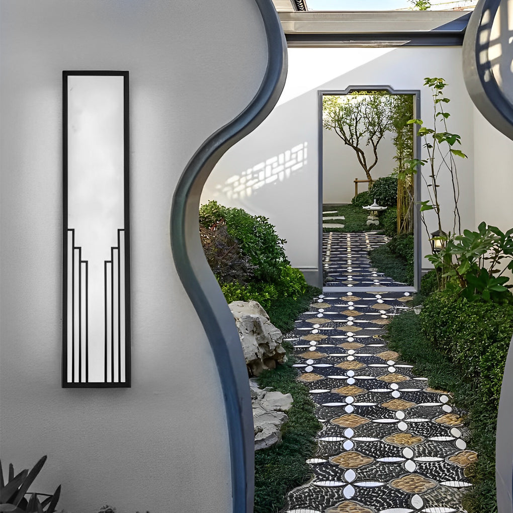Rectangular exterior wall sconce with a minimalist design, providing warm light near a garden path.