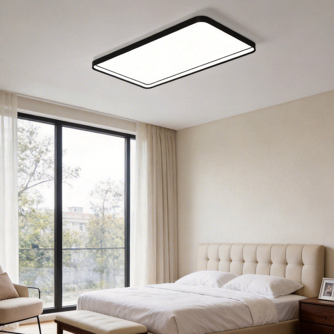 Rectangular flush mount ceiling light with a sleek design, enhancing a contemporary bedroom.
