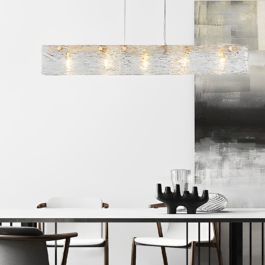 Rectangular glass chandelier with a close-up of its sparkling glass and gold frame.