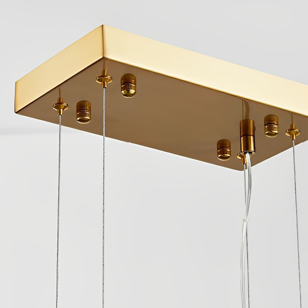 Rectangular glass chandelier with a close-up of its textured glass and gold accents.