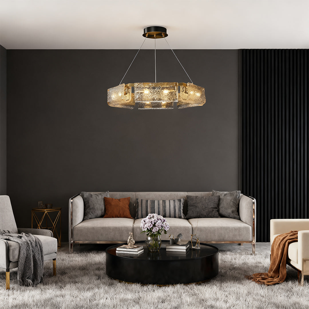 Rectangular glass chandelier above a gray sofa, adding a touch of elegance to the interior.