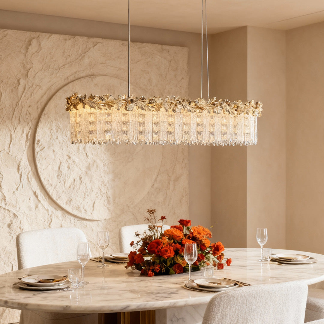 Rectangular gold crystal chandelier in bright modern dining space.