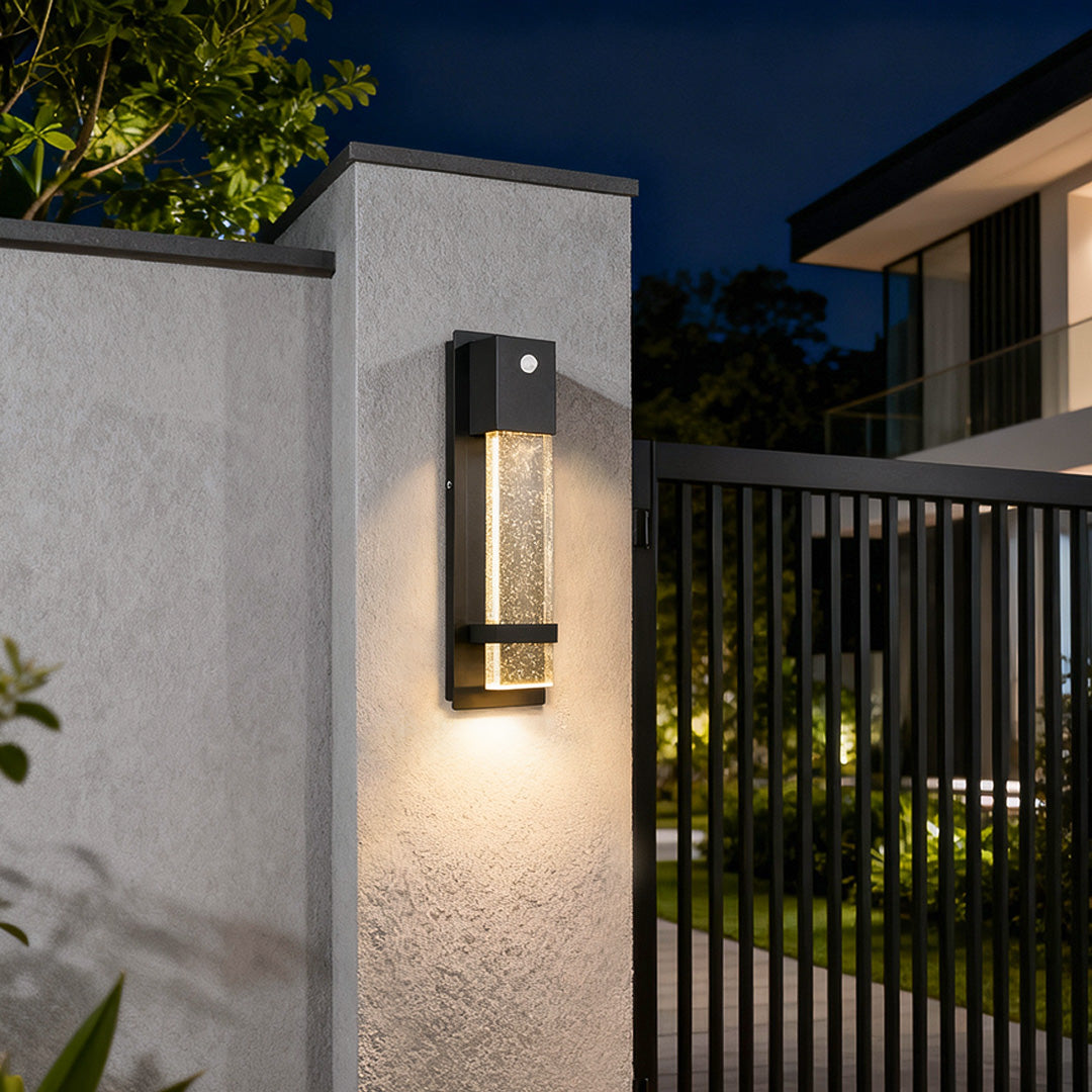 rectangular outdoor wall lights installed near a gate for warm security lighting