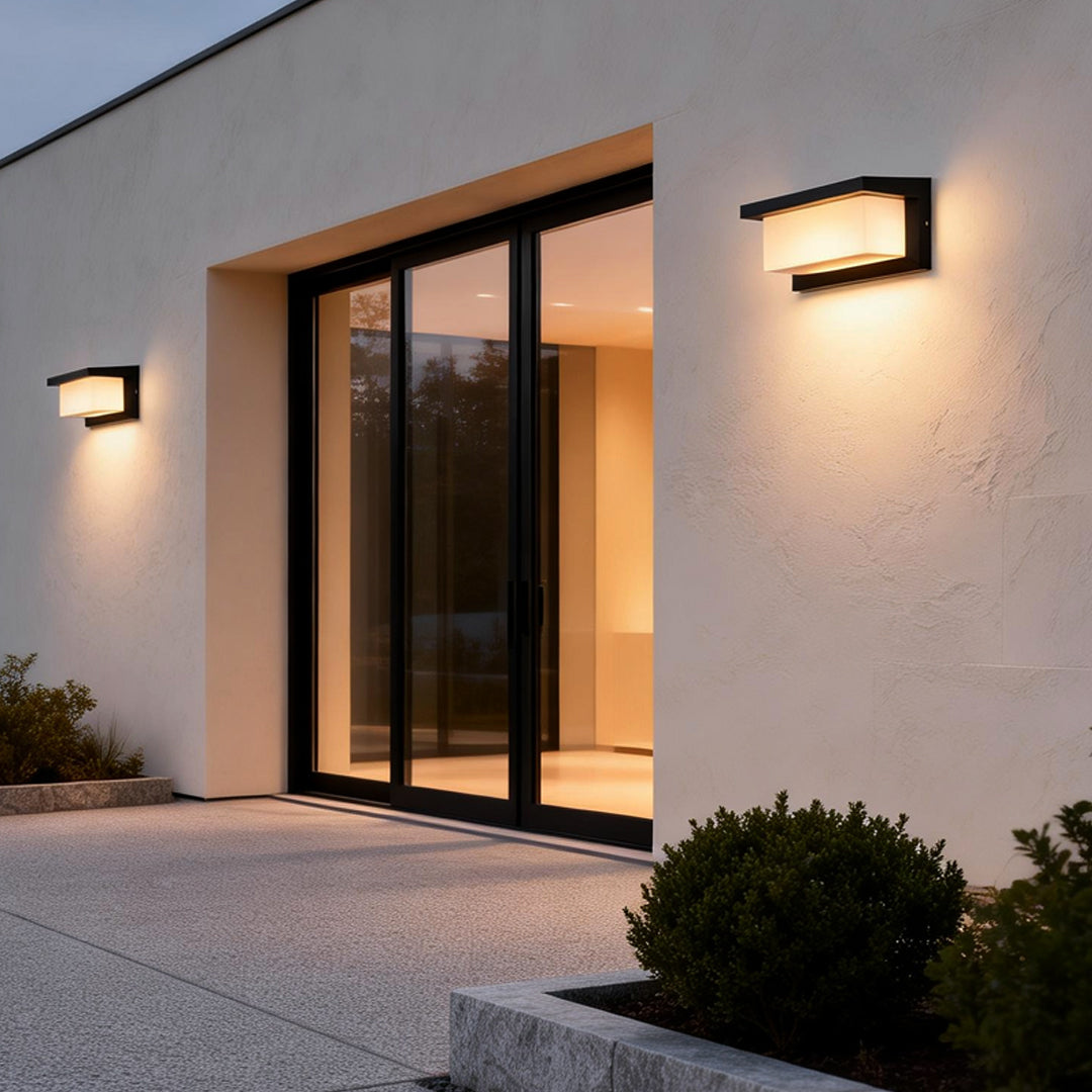 Rectangular outdoor wall lights illuminating a modern house entrance with warm directional glow.
