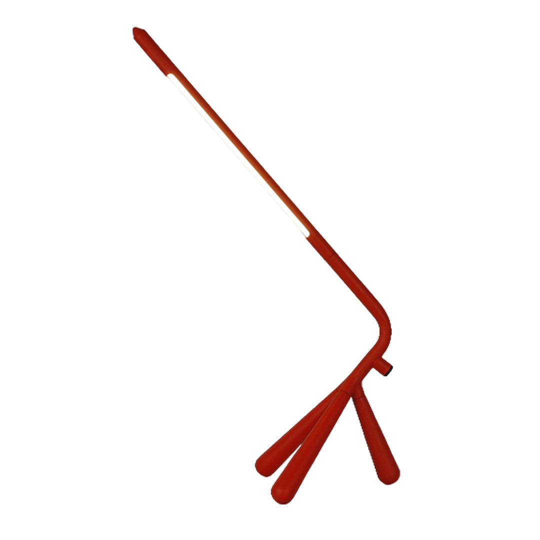 Contemporary three legged table lamp with vibrant red finish and adjustable arm for task lighting