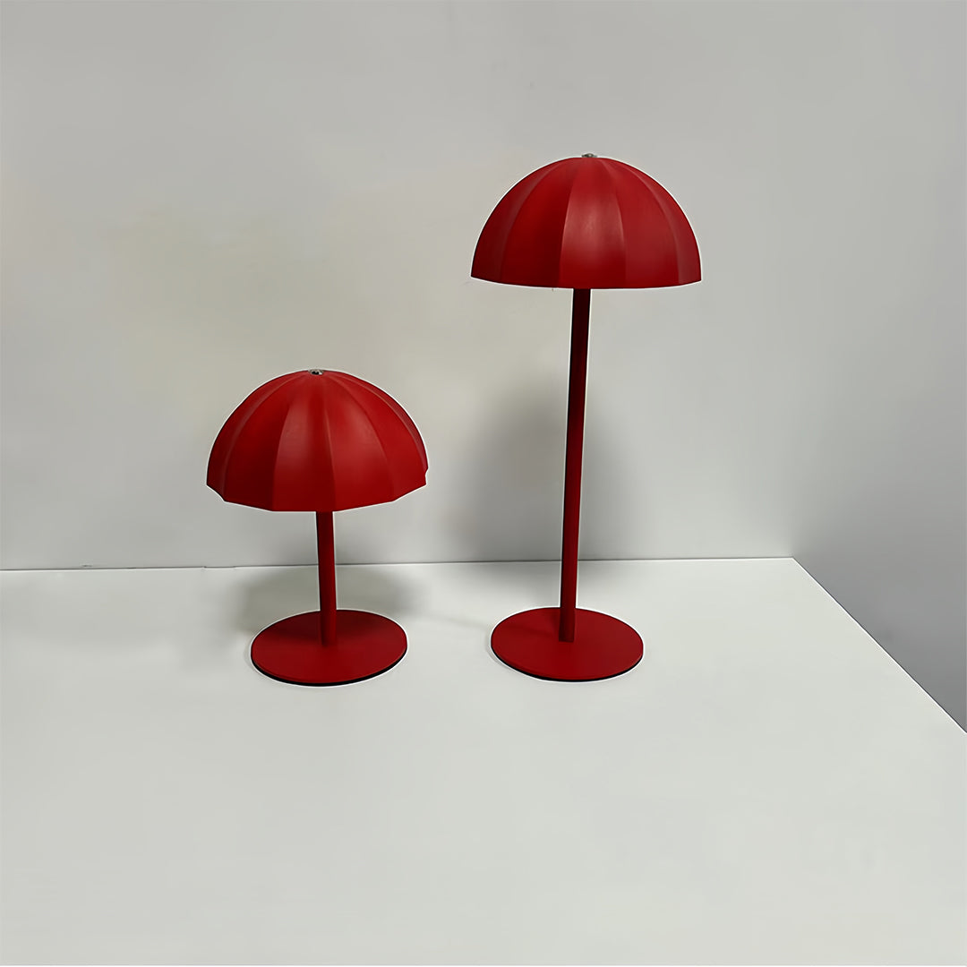 Pair of red iron table lamps creating ambient lighting on white minimalist surface