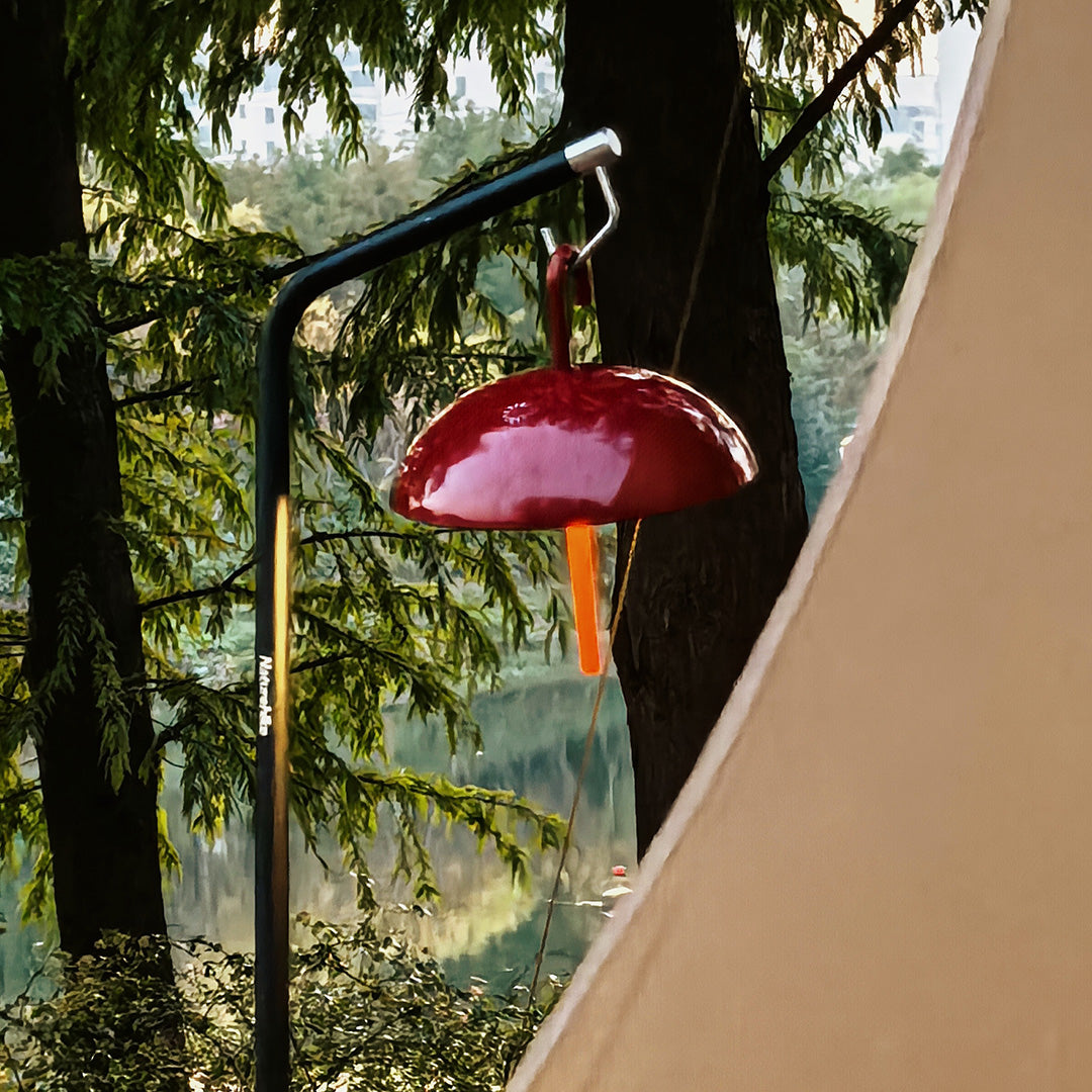 Red mushroom-shaped USB rechargeable table lamp providing whimsical outdoor accent lighting