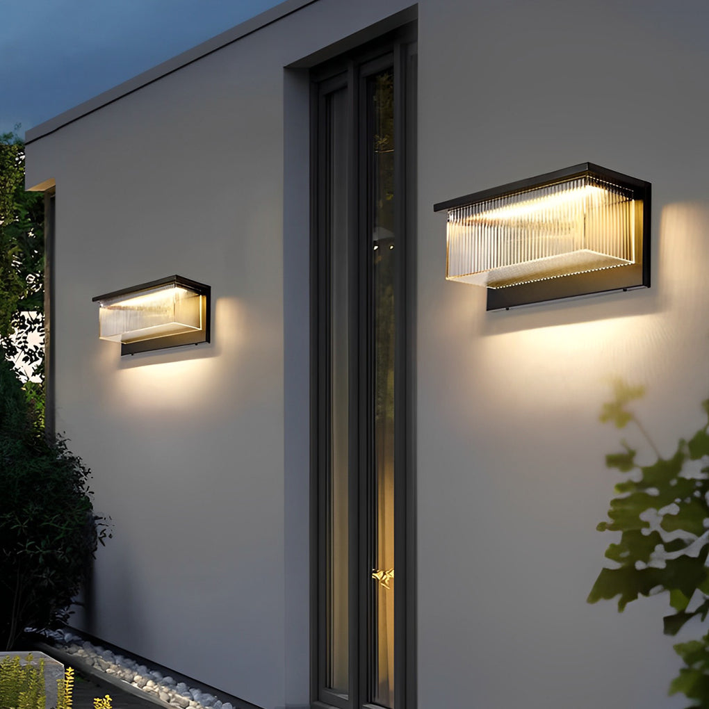 Reeded acrylic sconce enhancing a contemporary exterior entrance with elegant directional light.