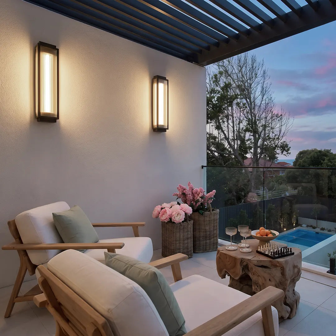 Reeded glass light installed on an outdoor patio wall above a modern seating area.