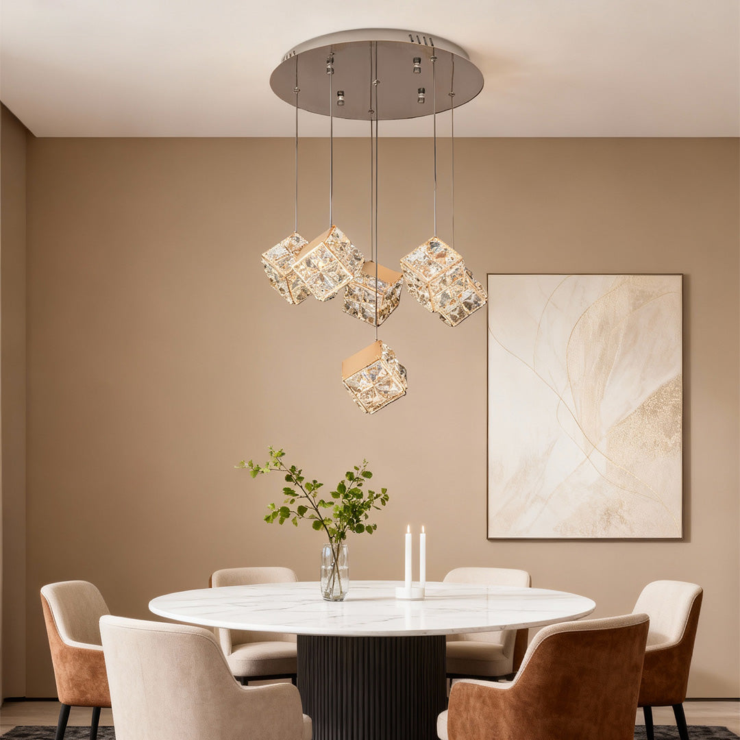 Refined chandelier with crystals featuring glass shade chandelier design creating elegant focal point above round white dining table.
