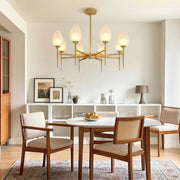 Refined glass modern chandelier featuring glass shade chandelier design creating sophisticated ambiance in transitional dining room.