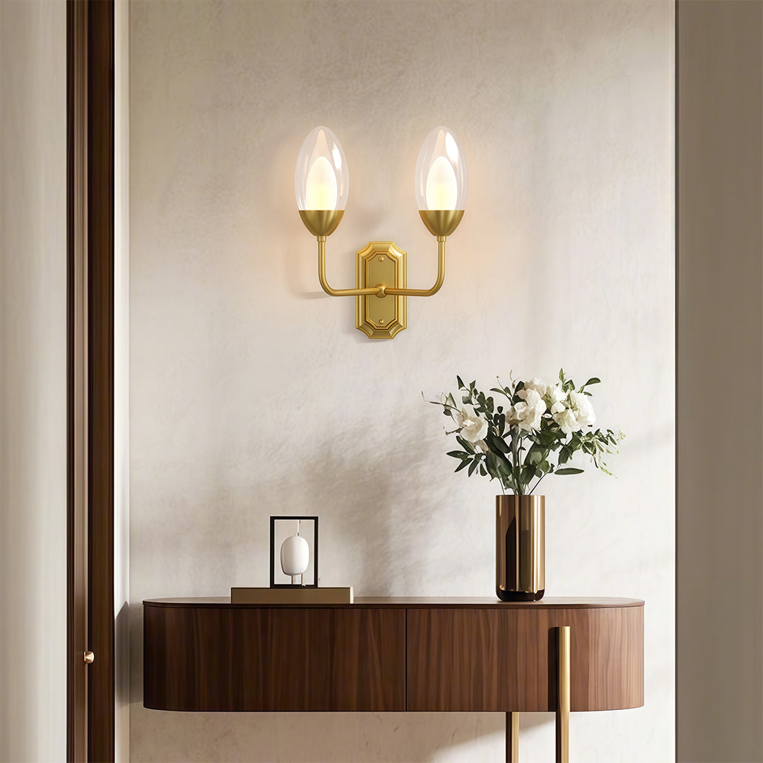 Refined glass wall light with glass shade chandelier aesthetic illuminating modern console with warm candle-like glow.