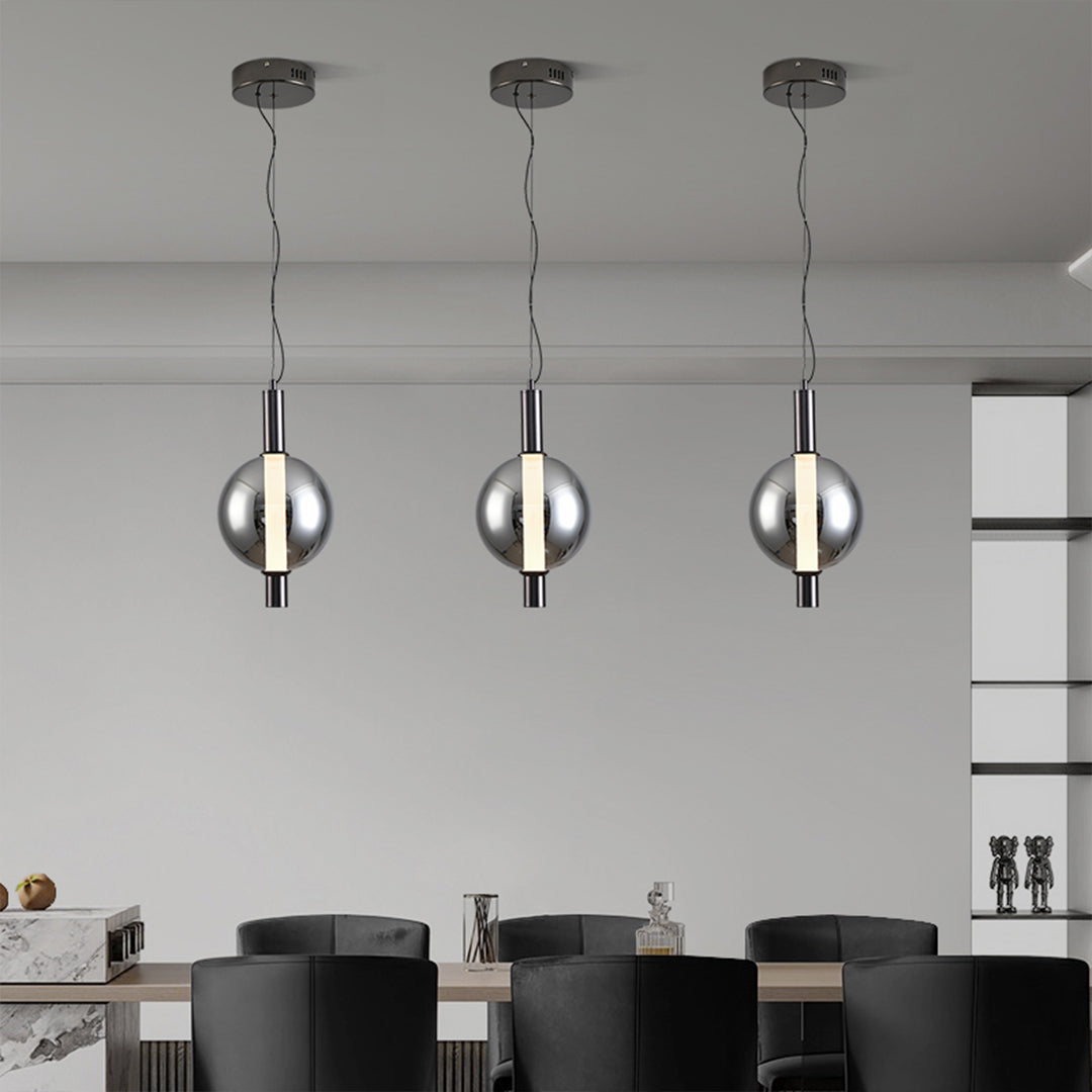 Reflective modern silver pendant light with mirror-like spherical globe creating dramatic lighting effects