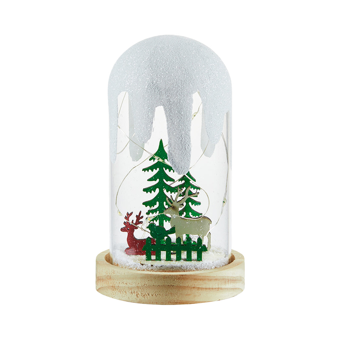 Snow-covered dome light with reindeer and evergreen tree, glowing softly like a white glass table lamp.