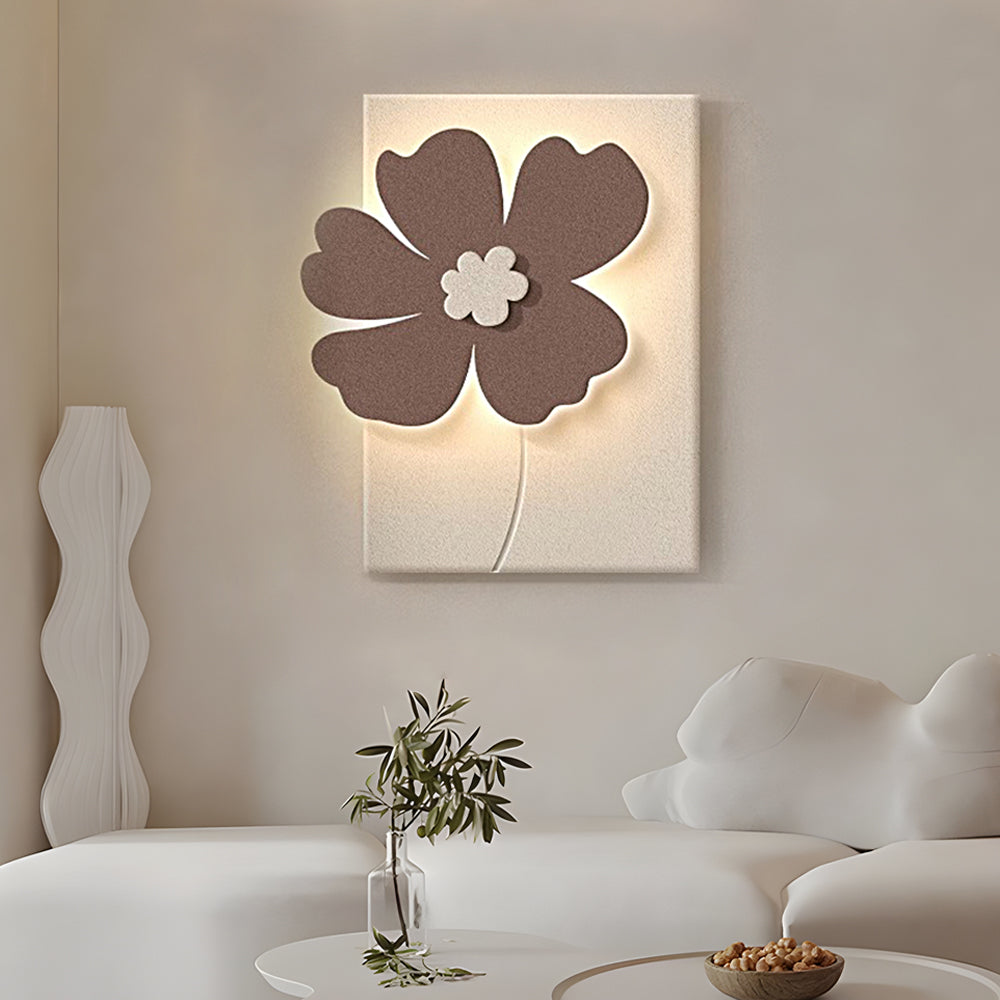 Relief wall lamp with a brown and white flower relief, mounted on a light-colored wall.