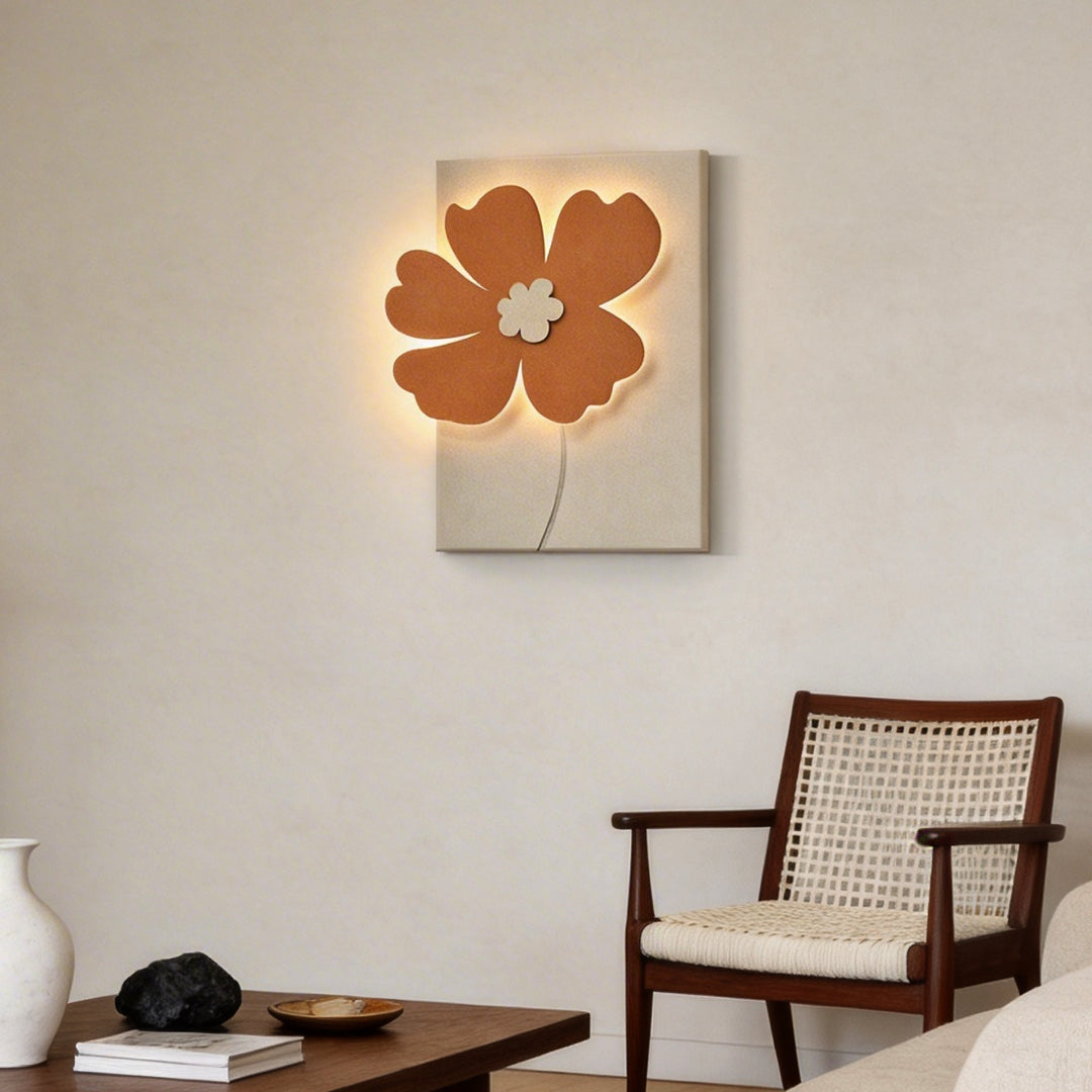 Relief wall lamp with a floral relief design, illuminating a modern armchair area.