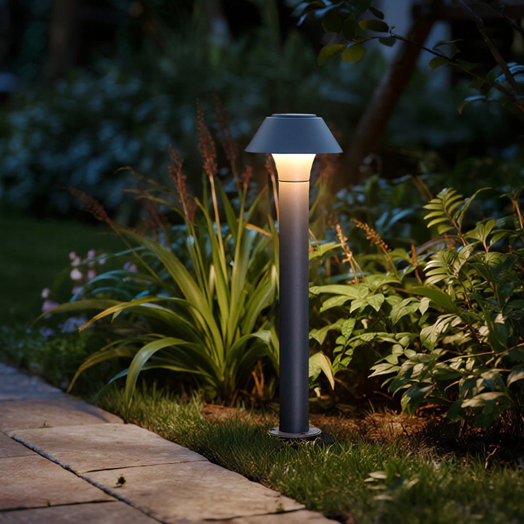 Residential bollard lights highlighting plants and greenery, adding depth and safety to residential outdoor walkways.