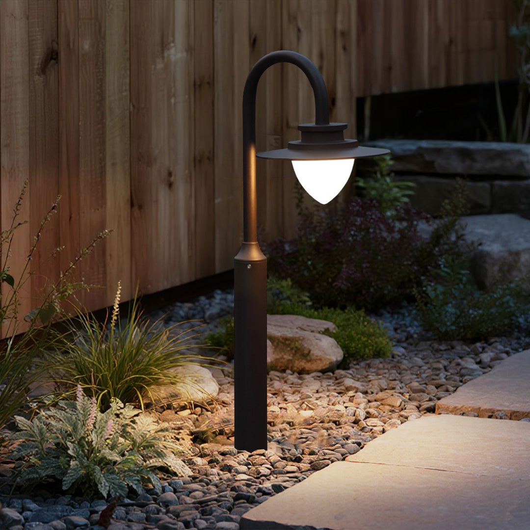 Residential outdoor lighting showcasing curved bollard fixtures along modern architectural landscaping