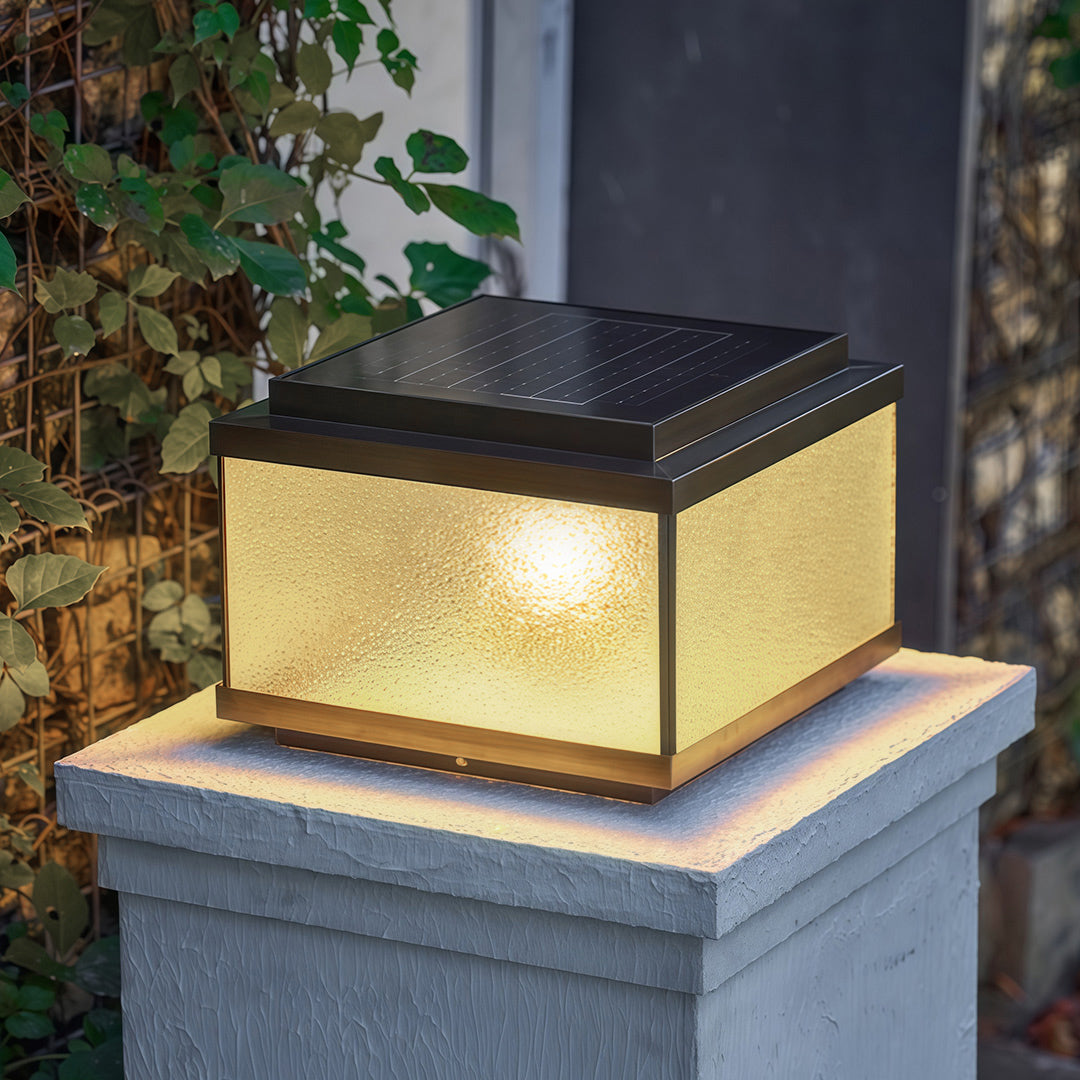 Garden pillar lights on granite posts framing residential entrance with red brick home backdrop
