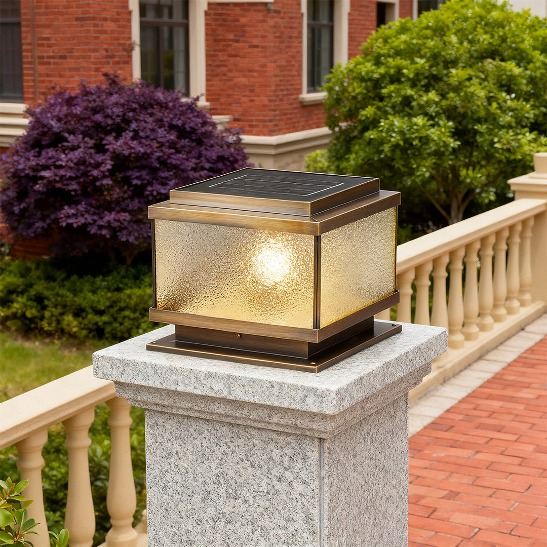 Garden pillar lights on granite posts framing residential entrance with red brick home backdrop